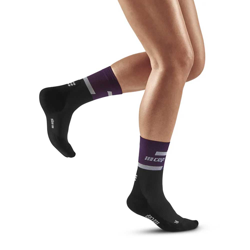 Brooks running shoes and CEP compression socks, legs female runner